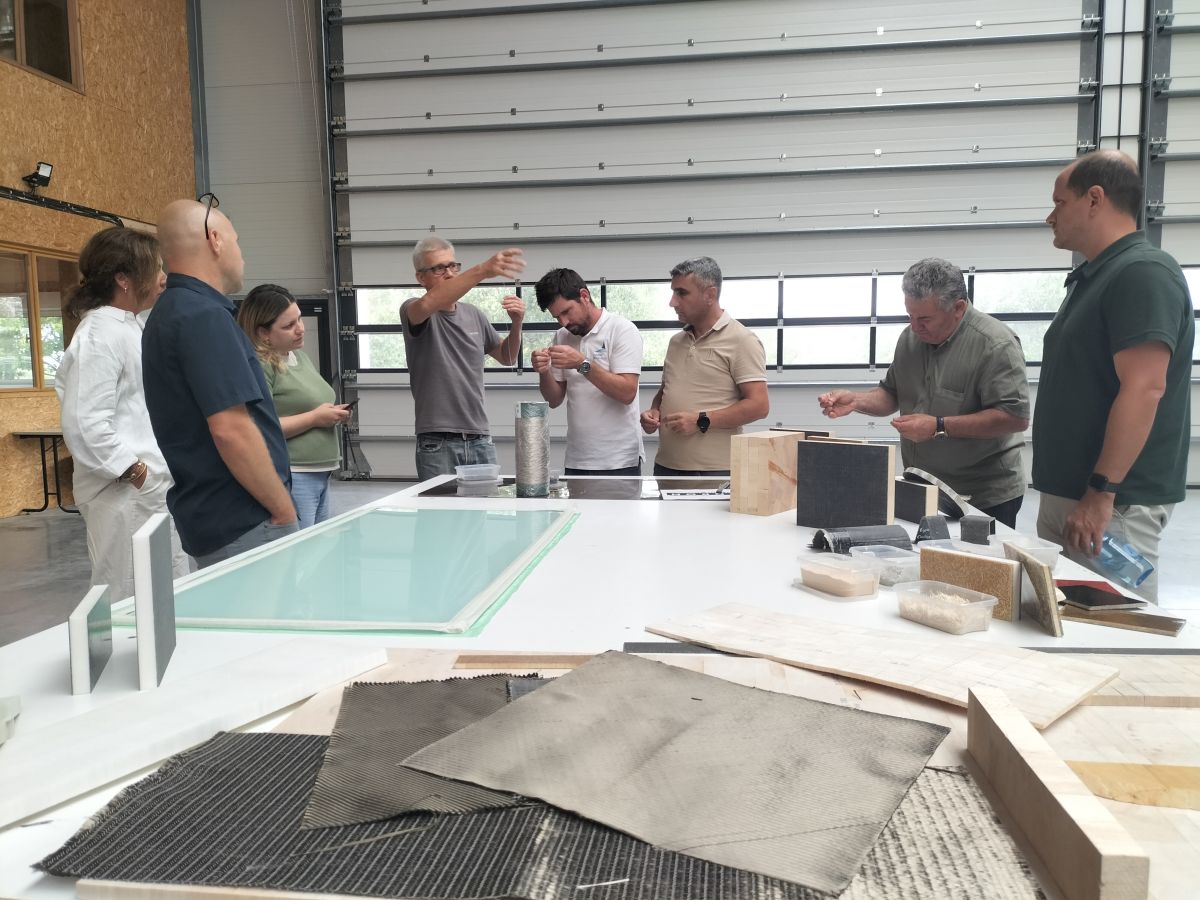 Team of partners from TEcoNaut project are around a table with several samples of innovative materials