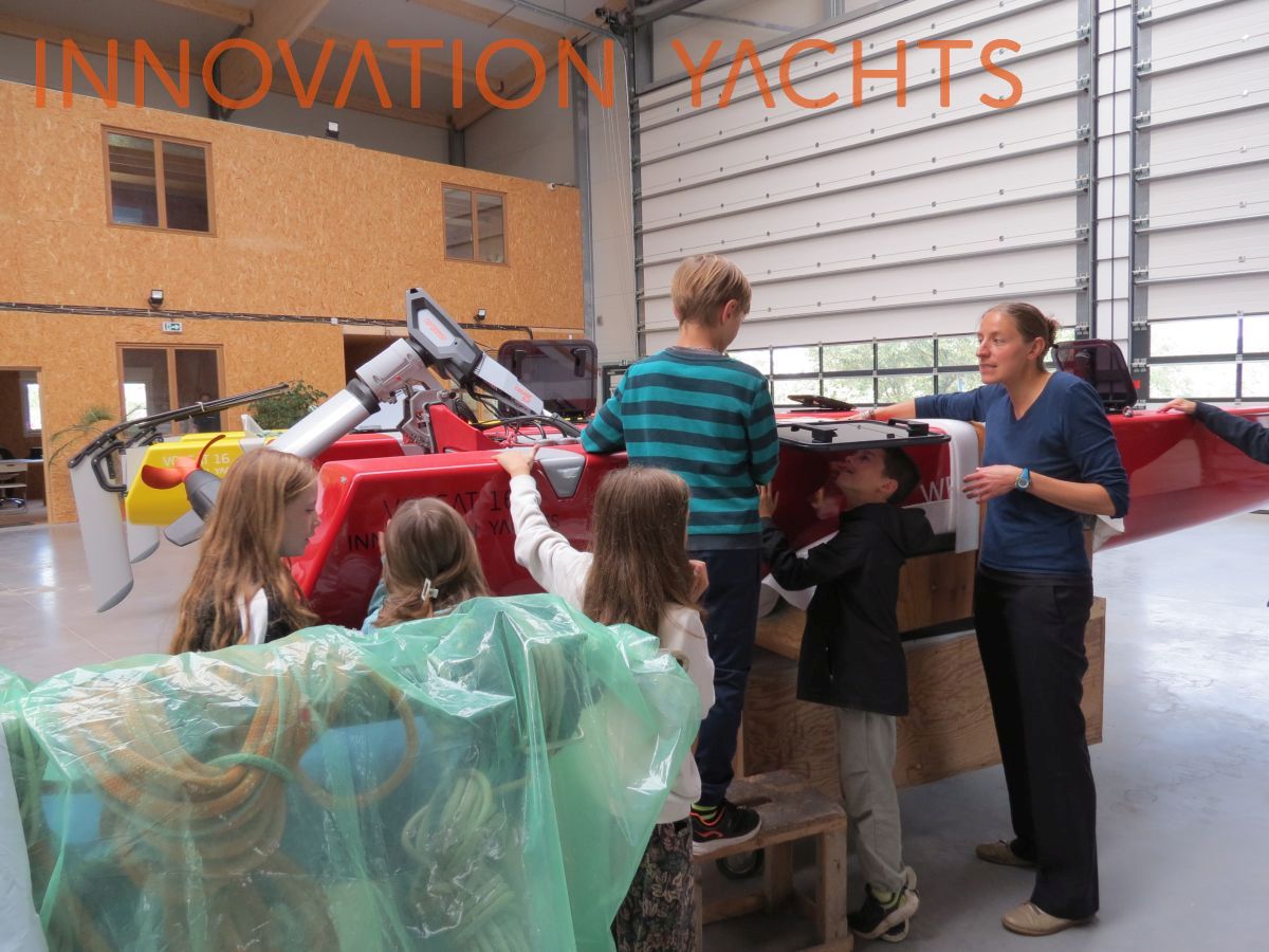 Group of children listening to explanation close to the Volcat16 motorised version
