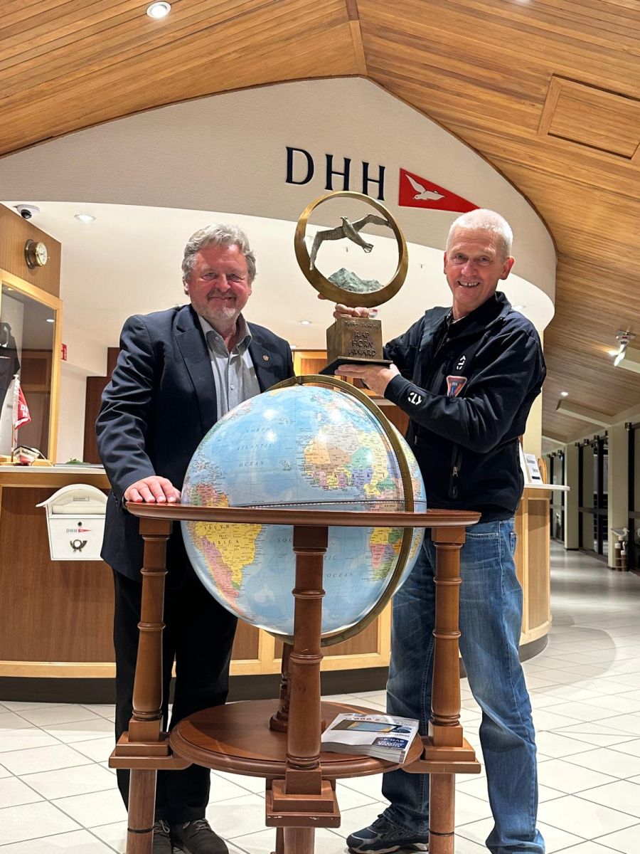 Gottfried Rieser and Norbert Sedlacek, with the cup from the Cape Horn award in his hands, behind a rather big globe
