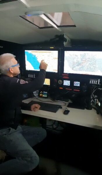 Norbert searching through a digital map on the navigation system in the IY Open60 AAL cockpit