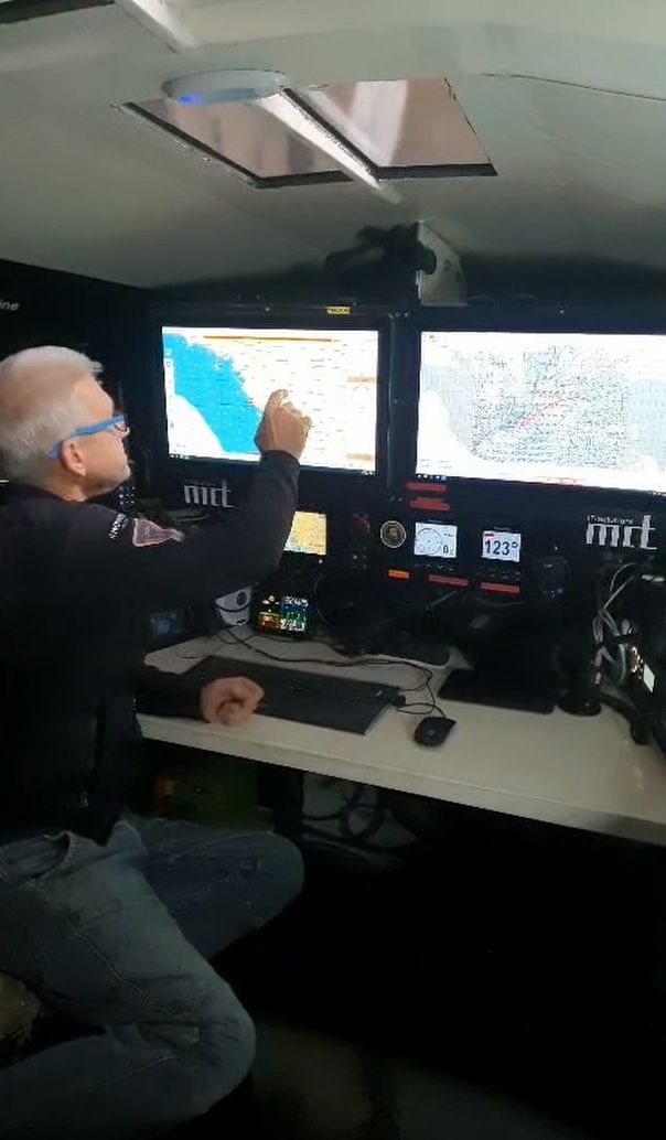 Norbert searching through a digital map on the navigation system in the IY Open60 AAL cockpit