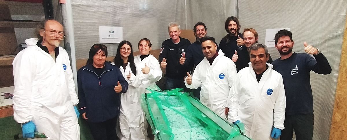 Team of the Skills Shadowing Workshop for TEcoNaut project behind the piece they laminated which is on vacuum