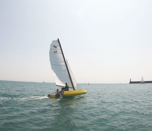 Yellow Volcat16 heeling in front of Les Sables d'Olonne pier
