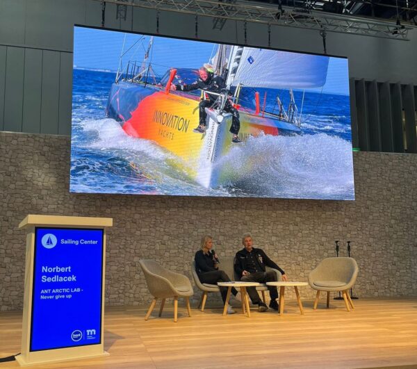 Norbert is giving the first speech, sitting on stage with a