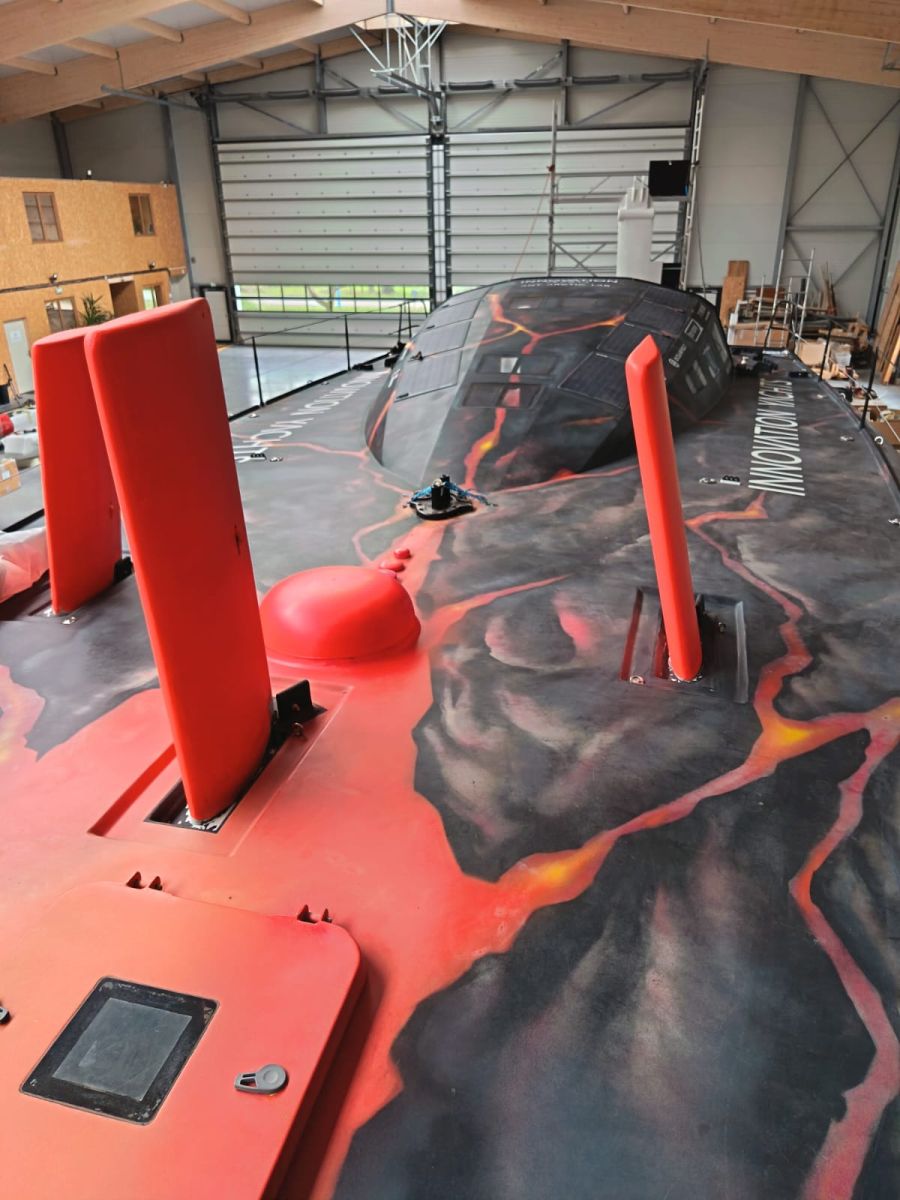 The three rudders with fresh antifouling fluo are up on the deck of the Open60AAL