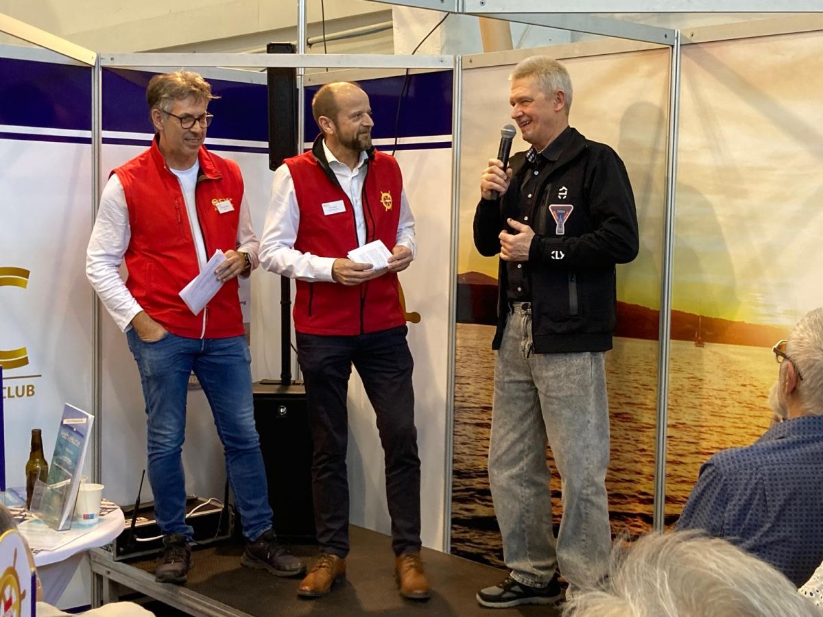 Norbert speaking and smiling on the stage of OSYC booth during the Austrian boat show in Tulln