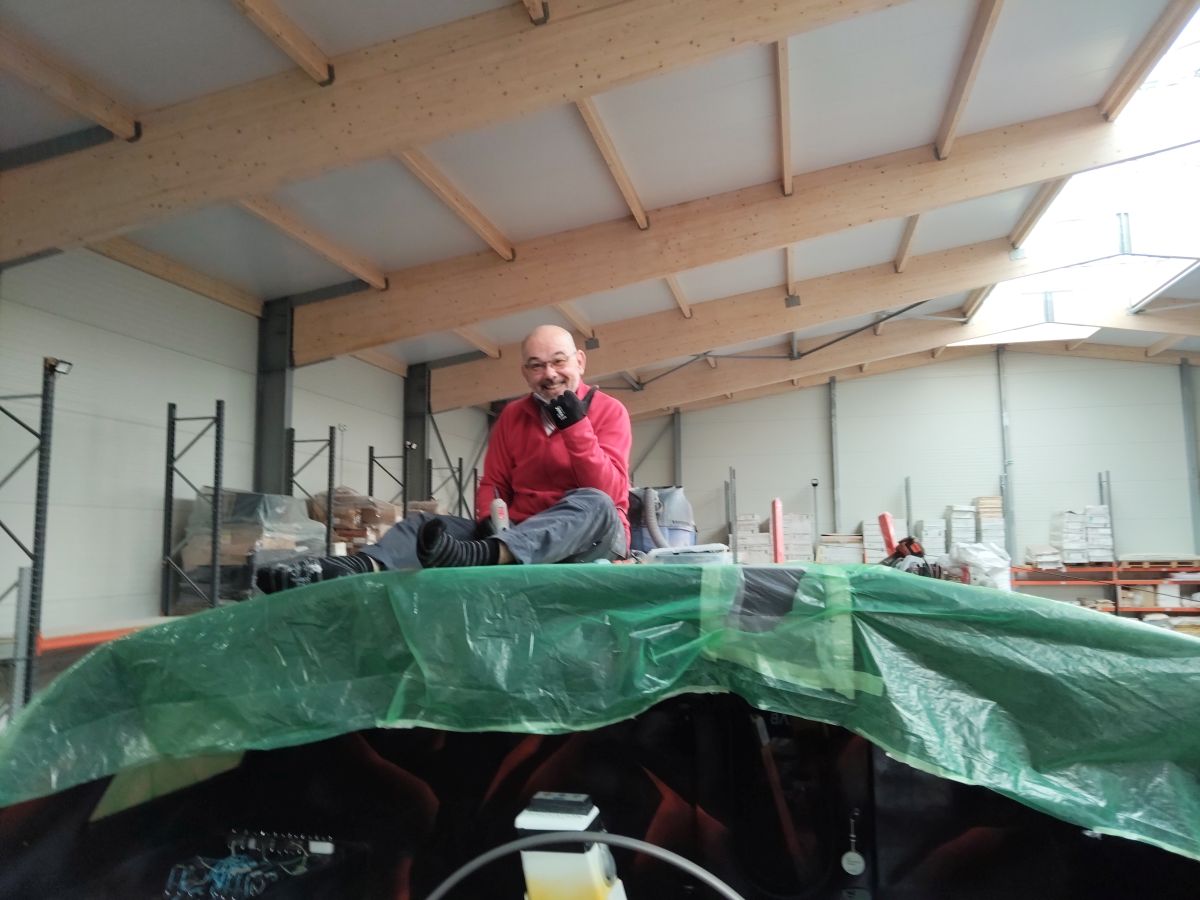 Edouard, crew member, is sitting on the deckhouse, thumb up, in socks and smiling !