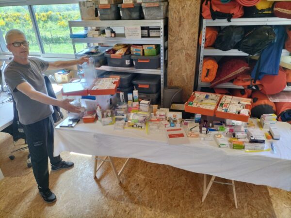 In his office, Norbert is showing the content of the first aid kit of the Open60AAL, displayed on a table.