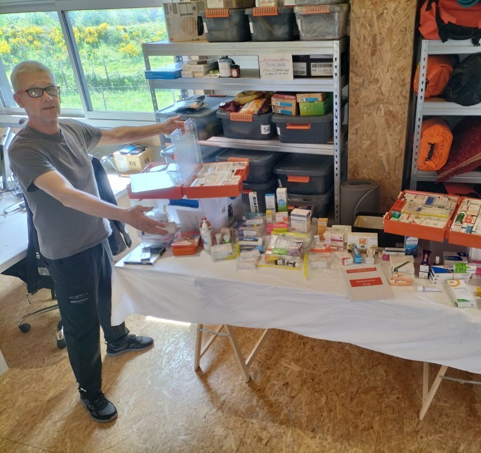 In his office, Norbert is showing the content of the first aid kit of the Open60AAL, displayed on a table.