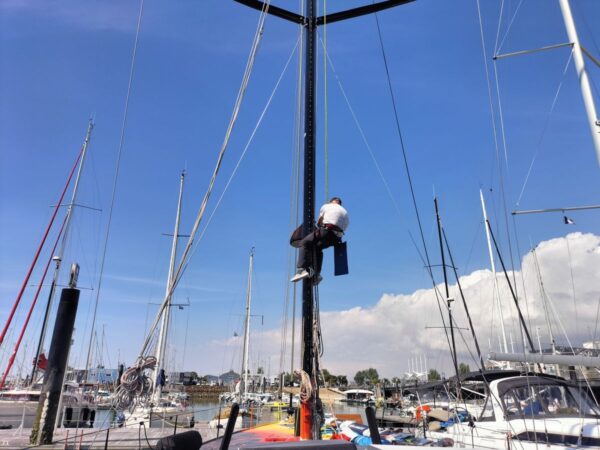 A team member is climbing the mast to adjust the rigging. - ANT ARCTIC LAB