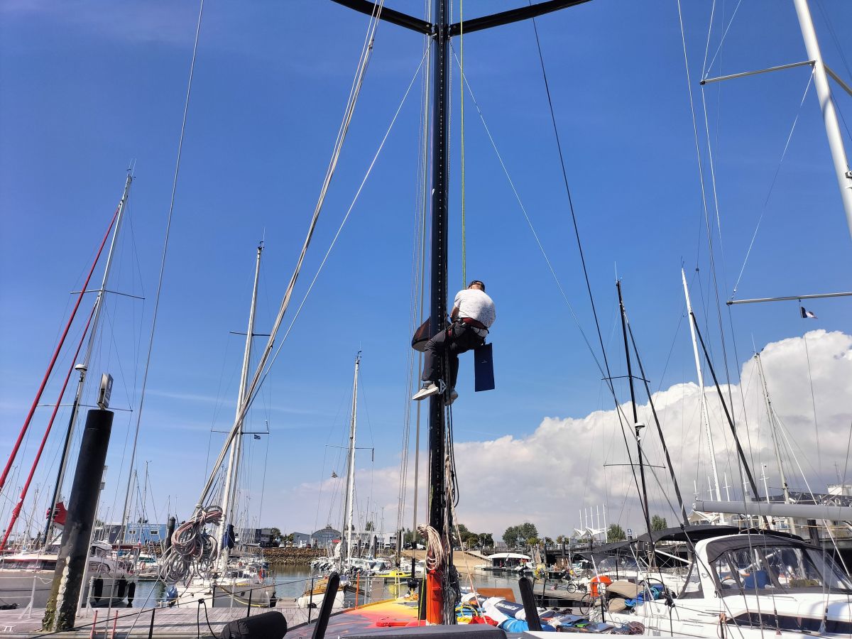 A team member is climbing the mast to adjust the rigging. - ANT ARCTIC LAB